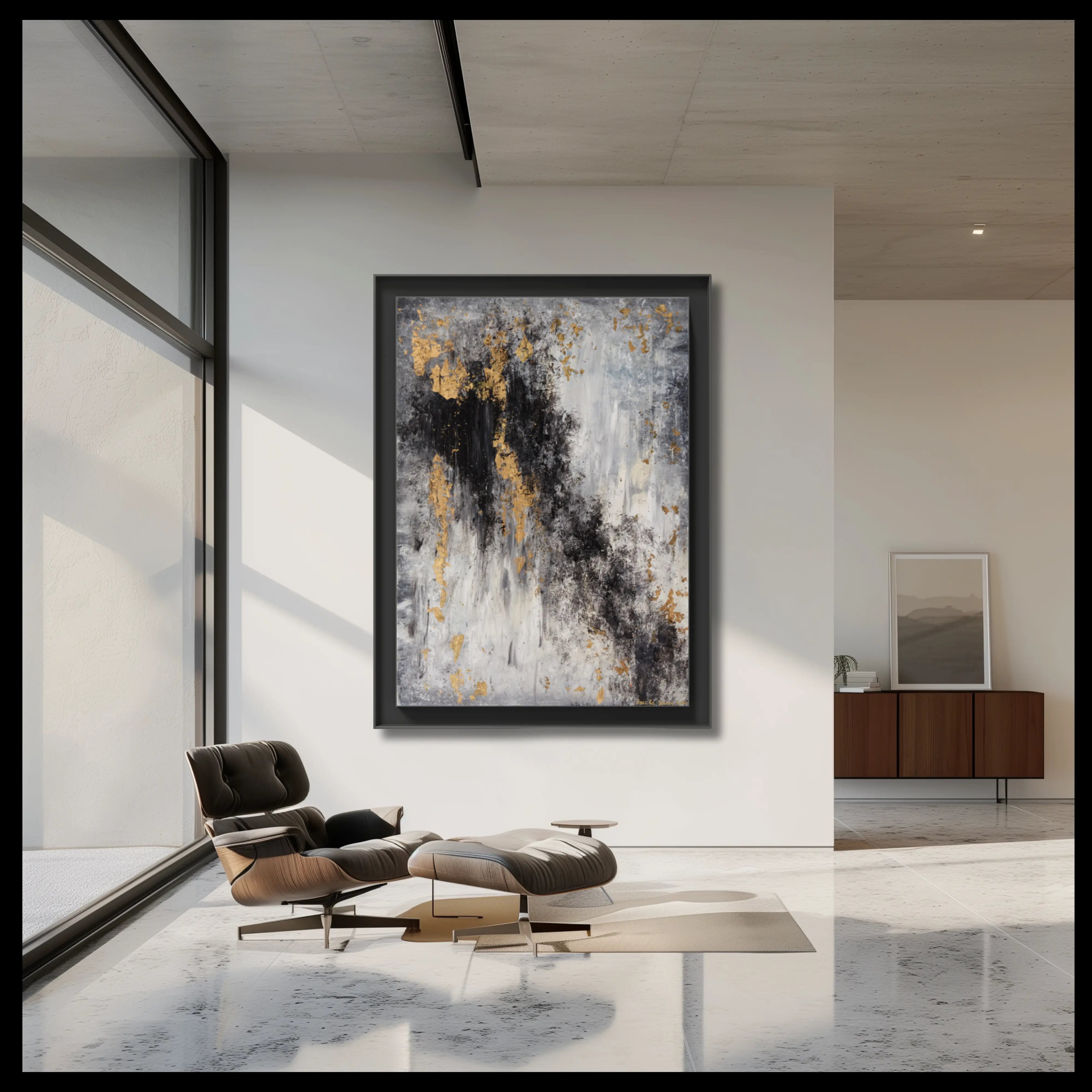 Modern minimalist living room with a designer armchair and a large framed abstract painting in black, gold and grey. 
